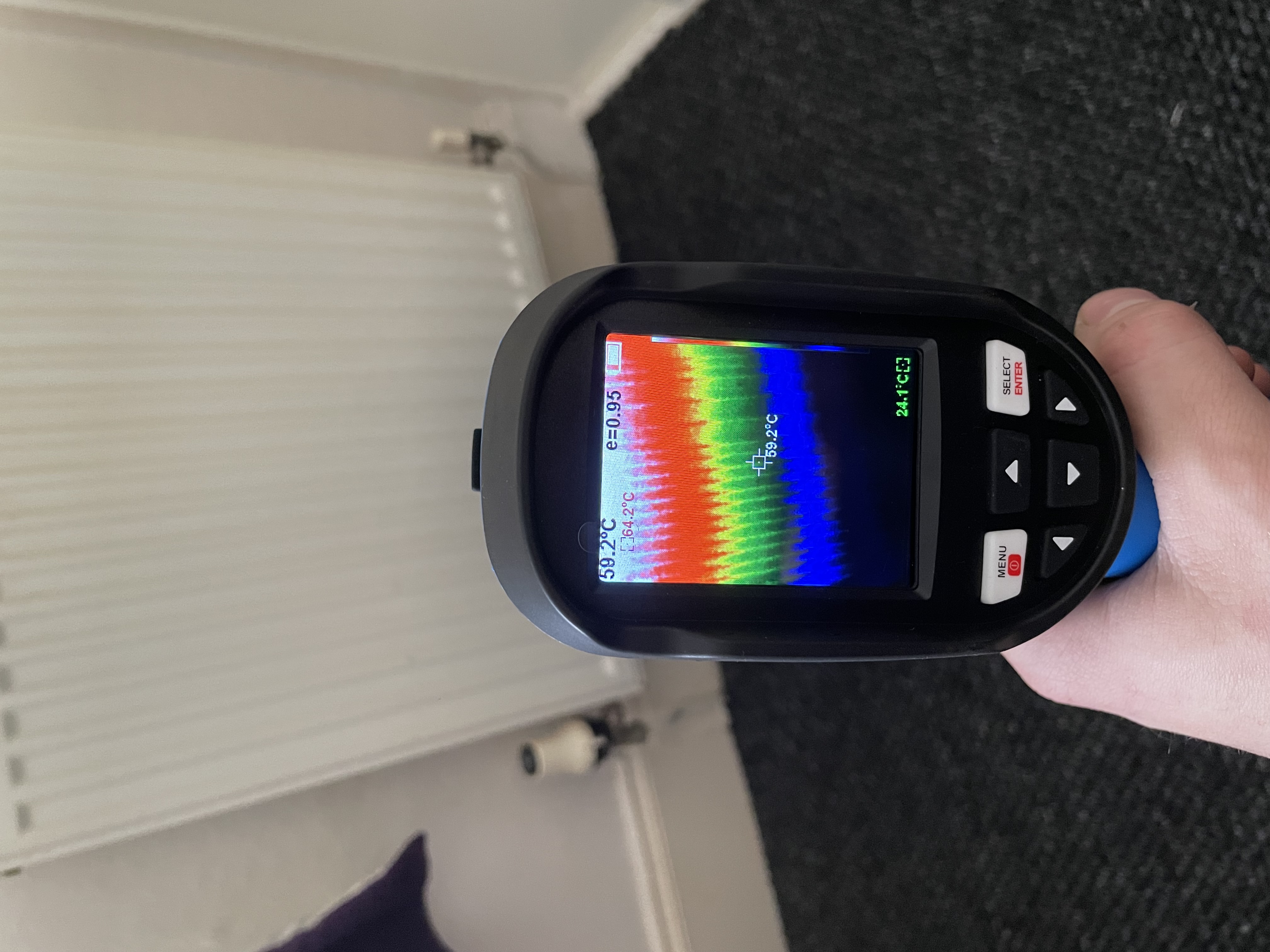 Thermal camera reading used to assess radiator heat performance in a Liverpool home