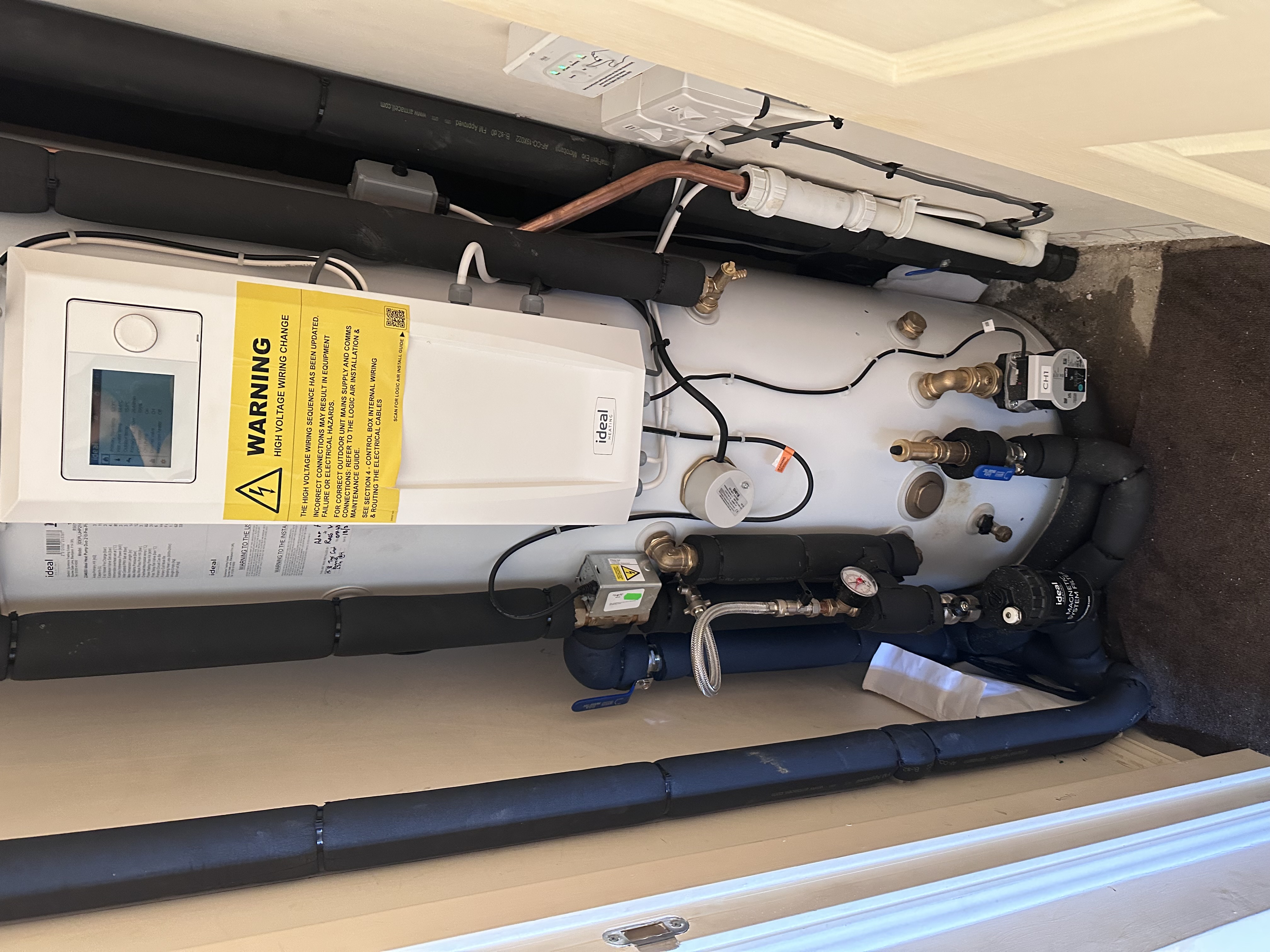 Renewable heating cylinder and insulated pipework installation in a loft space